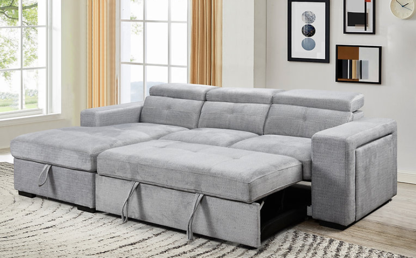 Canapé lit en tissu gris pale.